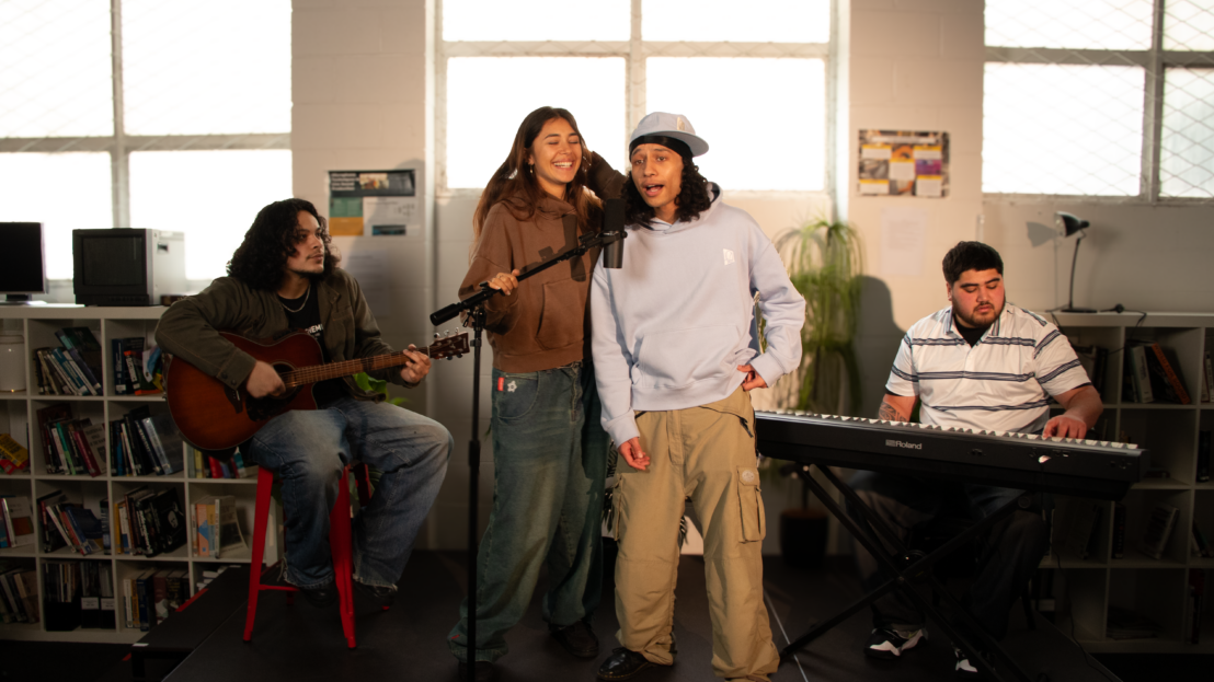 four Maori and Pacific Students on stage preforming